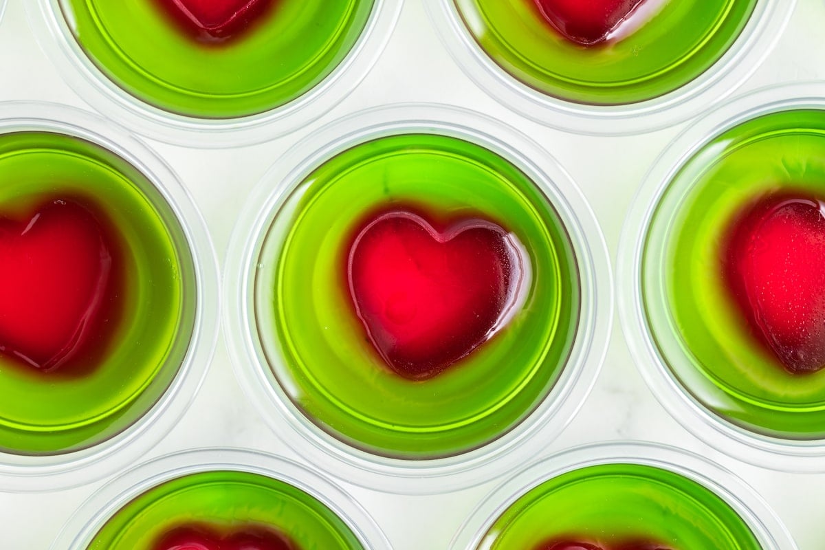 green jello in containers with a red heart in the center