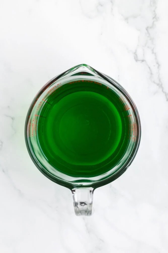 measuring cup of green jello mix